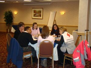 Maine DBHRT volunteers sitting at round table reviewing field strategies.